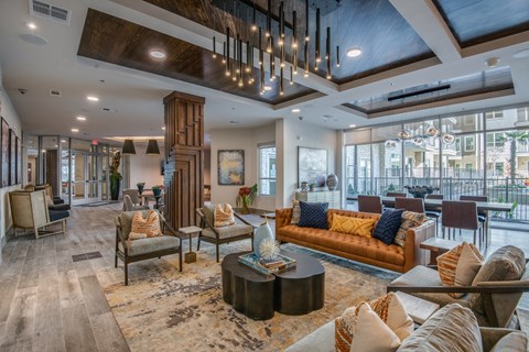 a living room with couches and chairs and a chandelier